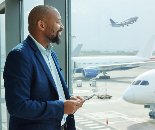 black-man-airport-smartphone-travel-with-communication-airplane-smile-business-trip-looking-out-window-waiting-flight-with-transportation-journey-airline-with-mobile (1)